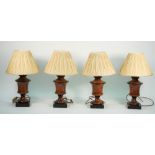 Four Victorian style wooden table lamps, each of turned urn form with cream pleated shades,