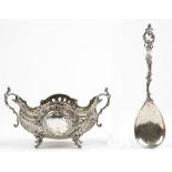 A silver twin handled bowl, of shaped oval form, with cast floral and scrolling decoration,