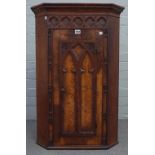 A 19th century oak and pollard oak Gothic Revival hanging corner cupboard,