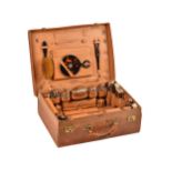 An Edwardian 9ct gold mounted lady's travelling toilet set with a pig skin case,