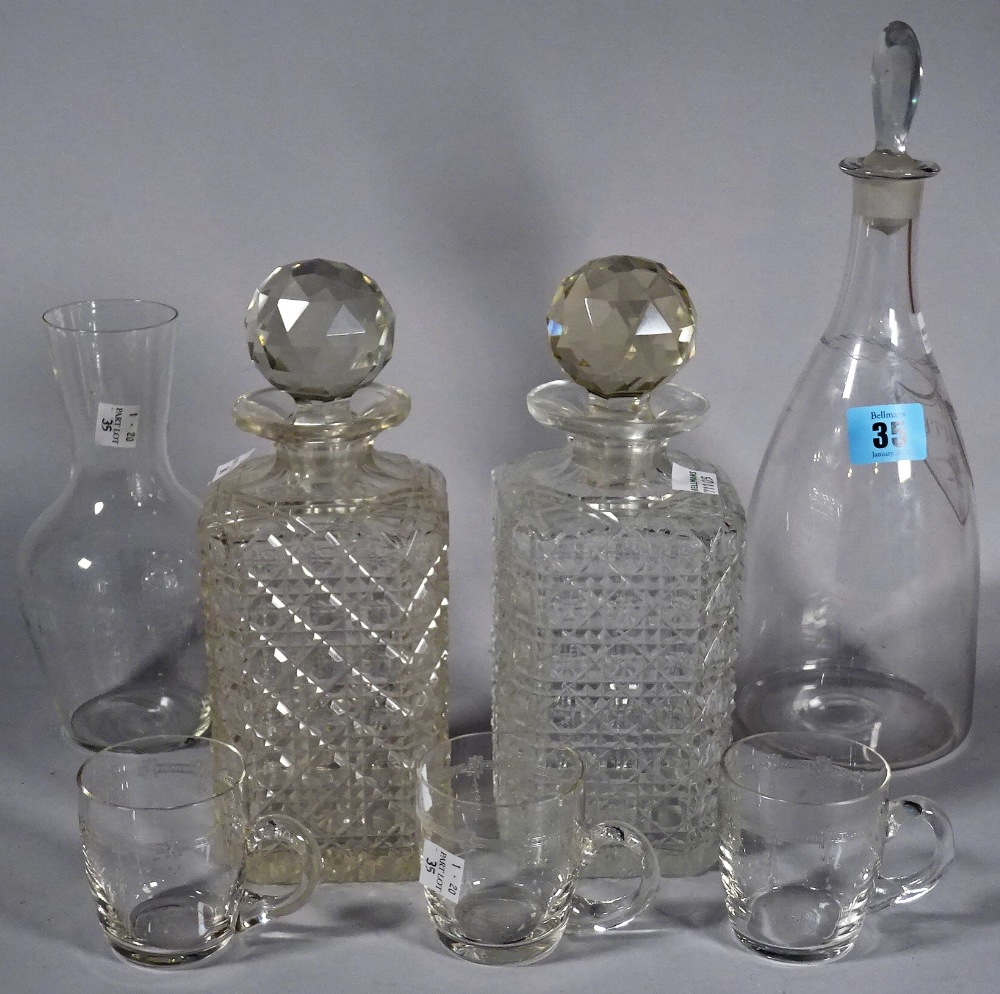 A glass decanter with engraved label, 'White', two square glass spirit decanters,