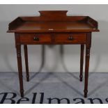 A Victorian mahogany two drawer side table on ring turned support, 86cm wide x 91cm high.