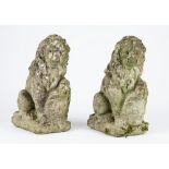 A pair of reconstituted stone figures of sergeant lions holding a shield, 16cm wide x 38cm high,