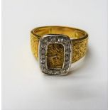 A gold and diamond set ring, with a buckle motif, mounted with circular cut diamonds,