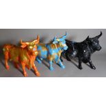 A group of three 20th century painted composite figures of a bull, each individually painted,