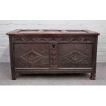 A 17th century oak coffer with triple panel lid over carved double panel front on stile feet,