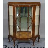 A 20th century walnut serpentine display cabinet on cabriole supports, 88cm wide x 116cm high.