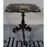 A Victorian ebonised and mother of pearl inlaid tripod table on three downswept supports,
