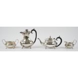 A silver four piece tea set, comprising; a teapot, a hot water jug,