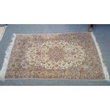 A fine part silk Esfahan rug, Persian, the ivory field with a brown shaped medallion,