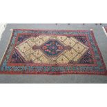 A Hamadan rug, Persian, the fawn trellis field with an indigo medallion,