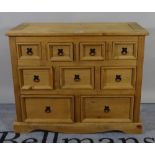 A 20th century pine chest of nine short graduated drawers on plinth base, 102cm wide x 83cm high.