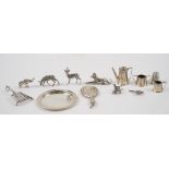 A group of mostly silver miniature wears, comprising; six models of animals, including a bird,