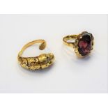 A gold and red enamelled ring, of expanding form, designed as a lion's head,