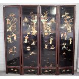 An early 20th century Chinese hardwood framed black lacquer four fold draught screen,