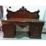 A Victorian sideboard, the carved and shaped back over three frieze drawers and pair of pedestals,
