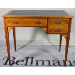 An Edwardian mahogany and inlaid writing table with two drawers and square tapering supports,