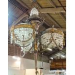 A French gilt metal and cut glass chandelier, modelled as a torch flanked by three baskets,