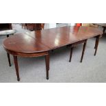 An 18th century mahogany extending dining table with central drop flap section,