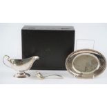 A Mappin & Webb silver sauceboat, with a sauce ladle and an oval stand,