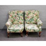 A pair of Victorian asymmetrical easy armchairs, on gilded scroll supports,