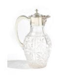 A silver mounted faceted glass claret jug, the spout formed as a Bacchus mask,
