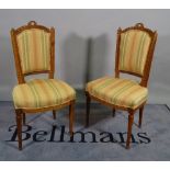 A pair of Louis XVI style stained beech salon chairs with fluted tapering supports,