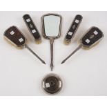 A silver mounted tortoiseshell part dressing set, comprising; a hand mirror,