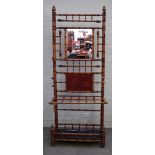 A Victorian bamboo hall stand, with central mirror in a hook surround over stick stand,