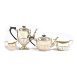 A silver four piece tea and coffee set, comprising; a teapot, a coffee pot,