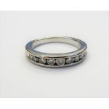 A platinum and diamond half hoop eternity ring,