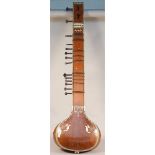 An Indian sitar with carved wood and ivory inlaid foliate decoration, applied trade label 'R.S.