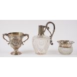An Irish silver twin handled cup, with later floral and scroll embossed decoration, a silver rimmed,