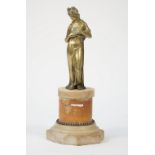 An early 19th century gilt bronze figure of a classical lady, mounted on a shaped marble socle, 27.