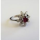An 18ct white gold, ruby and diamond ring, in an eight pointed star shaped design,