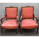 A pair of Louis XVI single square back open arm fauteuils, on tapering fluted supports,