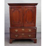 A small early 19th century mahogany linen press, with a pair of panel doors, over a pair of drawers,