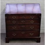An 18th century mahogany bureau, the fitted interior over four long graduated drawers,