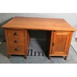 A mid-20th century oak pedestal desk