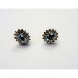 A pair of 9ct white gold, aquamarine and diamond set oval cluster earstuds,