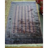 A machine made Bokhara design rug, 226cm x 150cm.