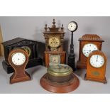 A group of eight early 20th century clocks, including; a porthole clock, 21cm wide,