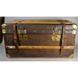An early 20th century leather and wooden bound trunk with brass mounts, 81cm wide x 40cm high.