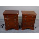 A pair of 20th century bedside chests of four long drawers, 43cm wide x 56cm high, (2).