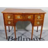 A George III mahogany bowfront sideboard with four short and one long drawer on tapering square