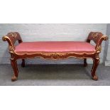 A Rococo Revival parcel gilt mahogany window seat with scroll ends and supports,