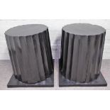 A pair of ebonised hardwood columns, with fluted bodies and square bases,