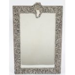 A silver mounted shaped rectangular strut backed mirror, fitted with a bevelled mirror glass,