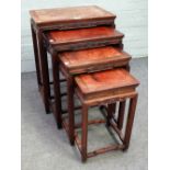 A nest of four Chinese hardwood and burrwood occasional tables, with carved frieze,