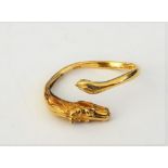 An 18ct gold ring, the terminals to the front designed as a horse's head and a horse's tail,